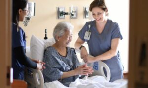 An elderly female patient being treated by the on-duty nurse.